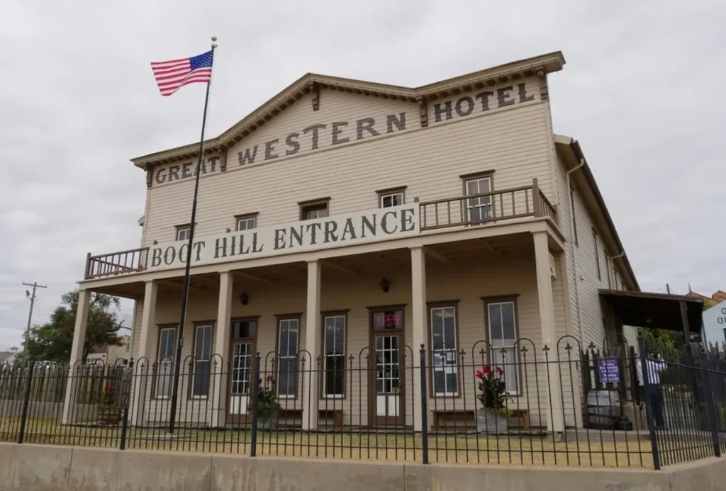 The historic Great Western Hotel building, which serves as the entrance to the Boot Hill Museum in Dodge City, Kansas, with an American flag flying out front.