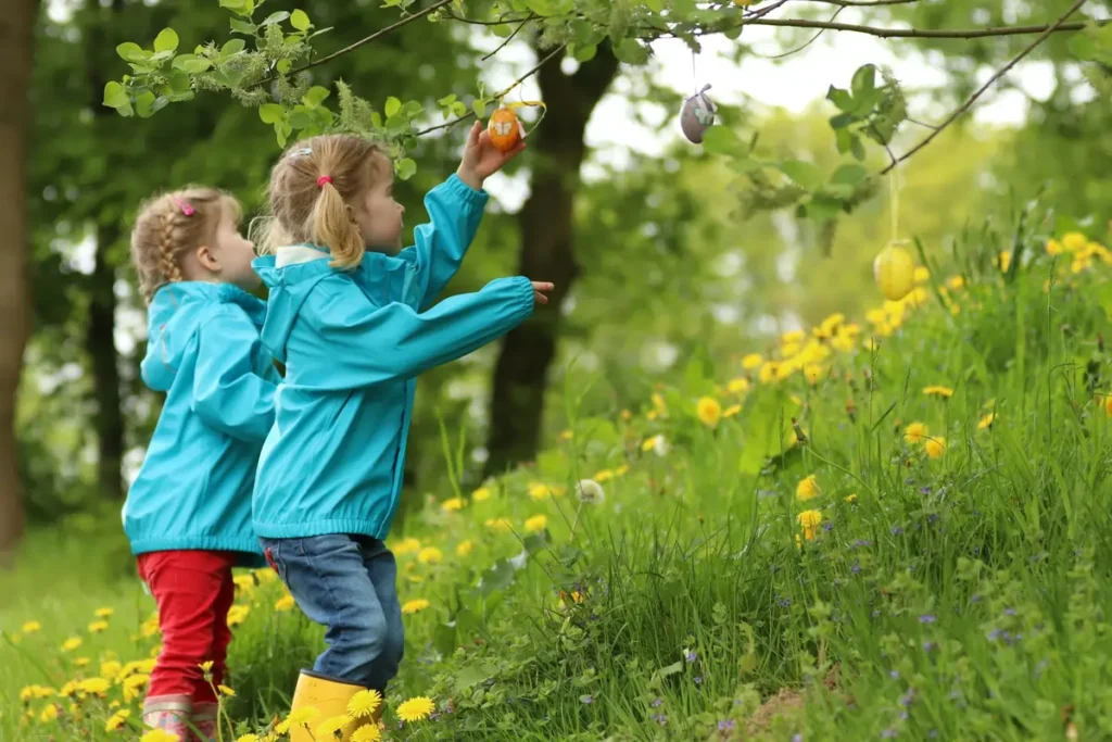 Two young girls in a grassy park in Brecksville, safely enjoying an Easter egg hunt, which represents the community's blend of nature and security.