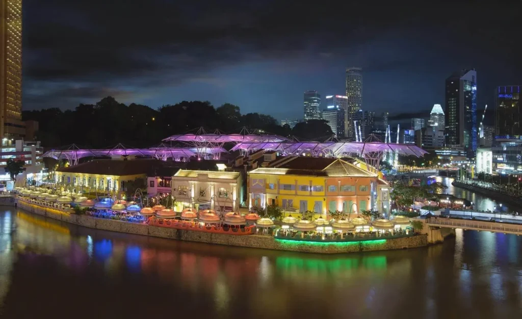 The colorful, illuminated riverside area of Clarke Quay in Singapore, one of the top cities in Asia for nightlife, with its distinctive umbrella-like canopies.