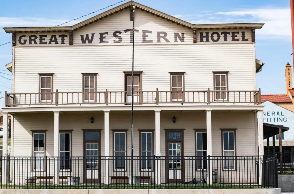 The historic Great Western Hotel in Dodge City, Kansas, a two-story wooden building that represents the town's famous Wild West heritage.