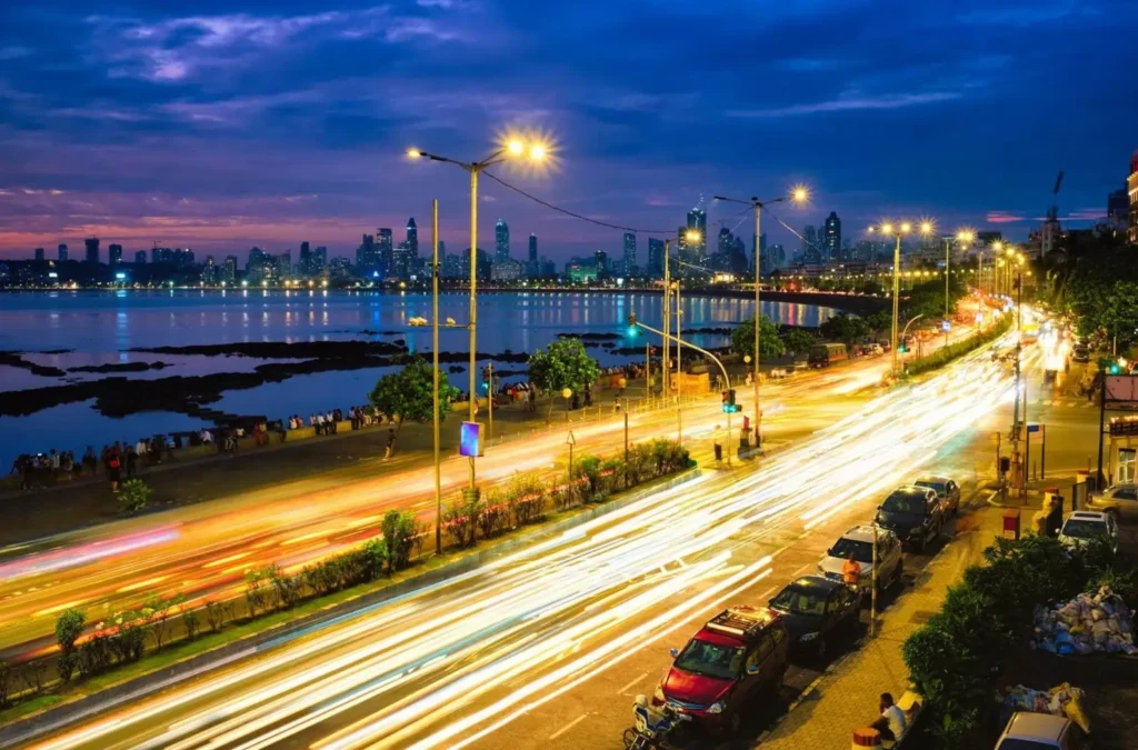 A long-exposure shot of Marine Drive in Mumbai at night, one of the top cities in Asia for nightlife, showing traffic light trails along the "Queen's Necklace."