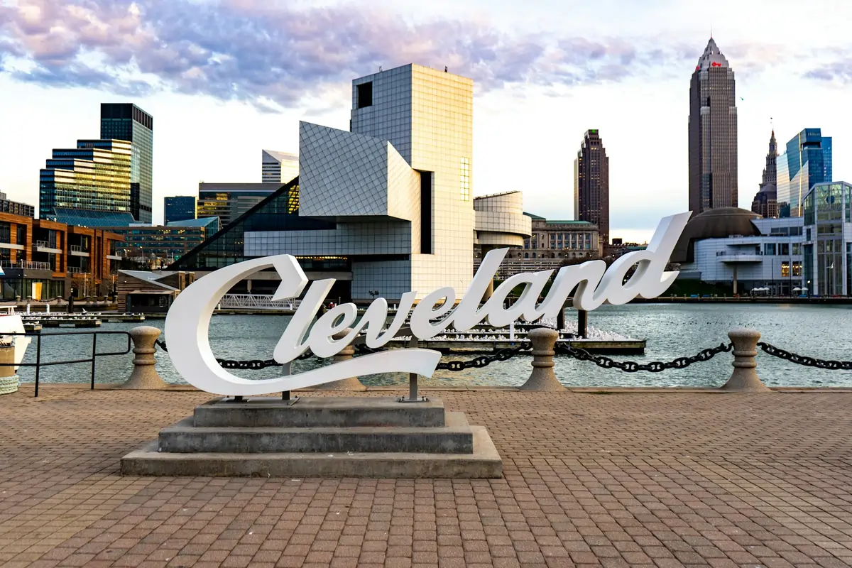 The Cleveland sign on the waterfront with the city skyline, representing the Safest Neighborhoods in Cleveland for Families.