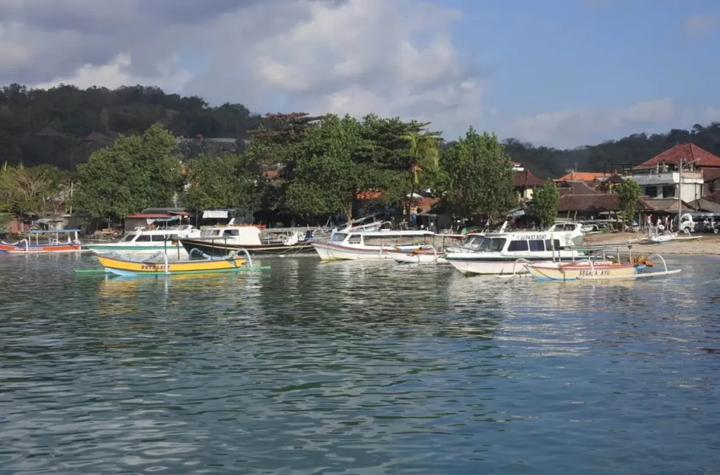 The harbor in Padang Bai, Bali, filled with traditional jukung boats and modern fast boats, a hub for some of the best diving Asia.