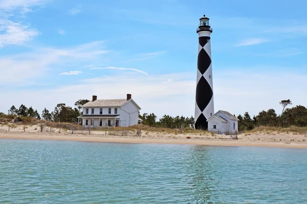 Aerial view of Cape Lookout Lighthouse and serene family-friendly beach on North Carolina's Outer Banks