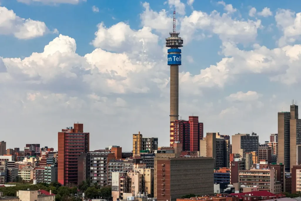 The skyline of Johannesburg, one of the major cities in South Africa, featuring the iconic Hillbrow Tower against a partly cloudy sky.