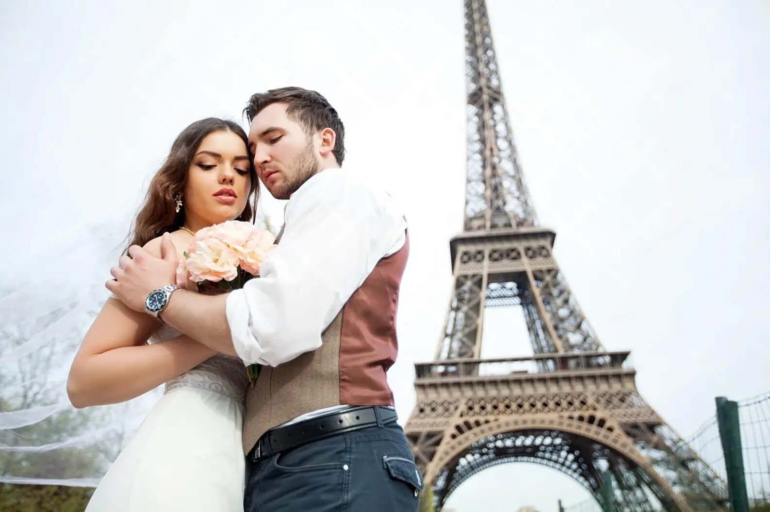 A romantic couple embracing in front of the Eiffel Tower, a perfect scene in Paris, City of Love.