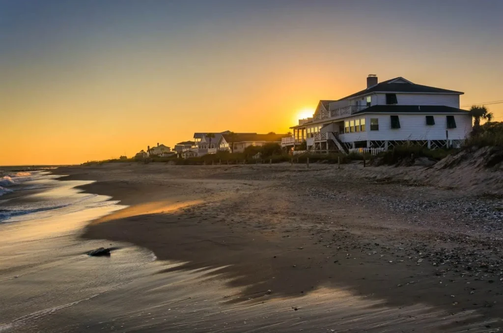 A beautiful sunset over the beachfront homes at Edisto Beach, one of the best hidden gem family beaches on the East Coast.